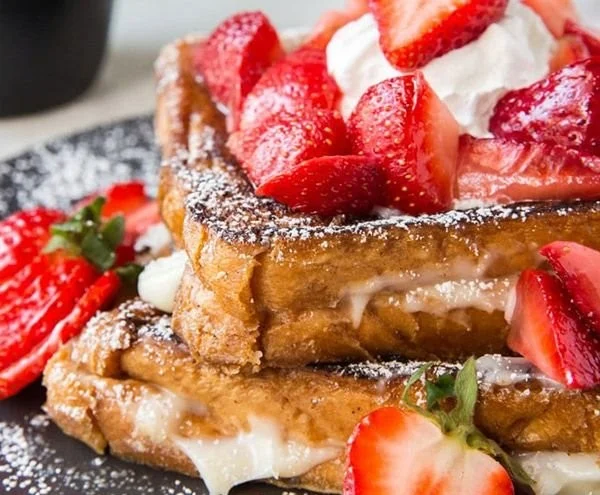 Delicious Stuffed French Toast with cream filling and fresh fruit toppings.